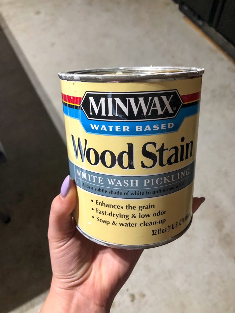 hand holding minwax whitewash pickling wood stain